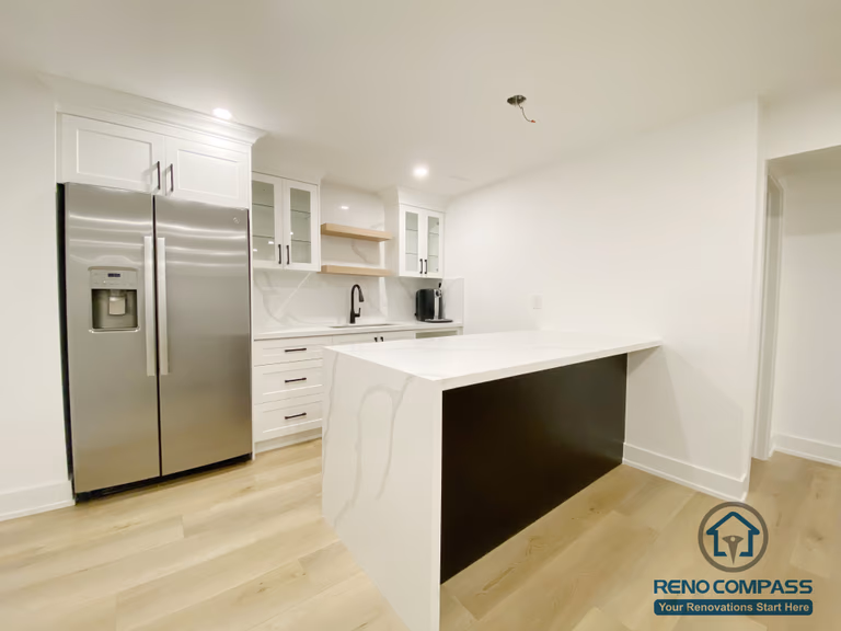 This modern basement kitchen includes a functional island layout, clean cabinetry, and efficient lighting. Designed to support entertaining and everyday use, the space seamlessly connects with the surrounding basement living areas.