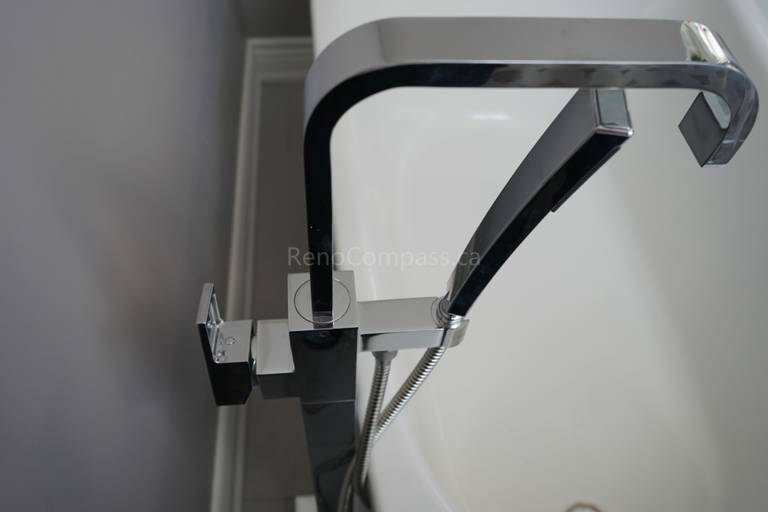 Close-up of a modern brushed nickel bathroom faucet installed on a marble countertop as part of a Markham bathroom renovation. The upgraded sink fixtures combine durability, functionality, and elegant design, adding a refined finishing touch to this clean and contemporary bathroom space.
