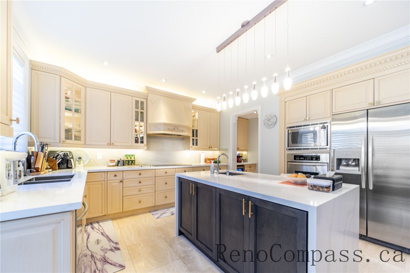 This Richmond Hill entire house interior renovation features a spacious luxury kitchen with a large central island, quartz countertops, and custom cabinetry. Modern pendant lighting and built-in appliances enhance both functionality and style, while the open-concept layout connects seamlessly to the living area. Designed for daily living and entertaining, this bright and elegant kitchen renovation was completed by a professional Toronto renovation company focused on craftsmanship, efficiency, and timeless design.