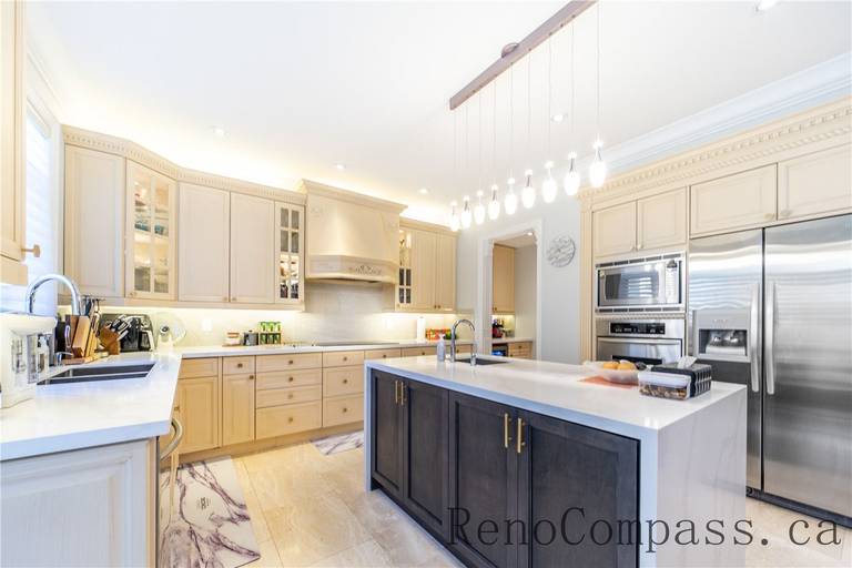 This Richmond Hill entire house interior renovation features a spacious luxury kitchen with a large central island, quartz countertops, and custom cabinetry. Modern pendant lighting and built-in appliances enhance both functionality and style, while the open-concept layout connects seamlessly to the living area. Designed for daily living and entertaining, this bright and elegant kitchen renovation was completed by a professional Toronto renovation company focused on craftsmanship, efficiency, and timeless design.