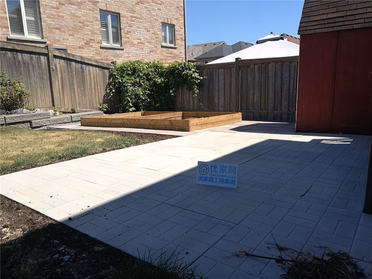 This Vaughan landscaping renovation features a newly installed stone tile patio that creates a clean and functional backyard outdoor space. The project also includes custom-built raised wooden garden beds and defined planting areas, providing both structure and visual balance while keeping the backyard low-maintenance and modern.