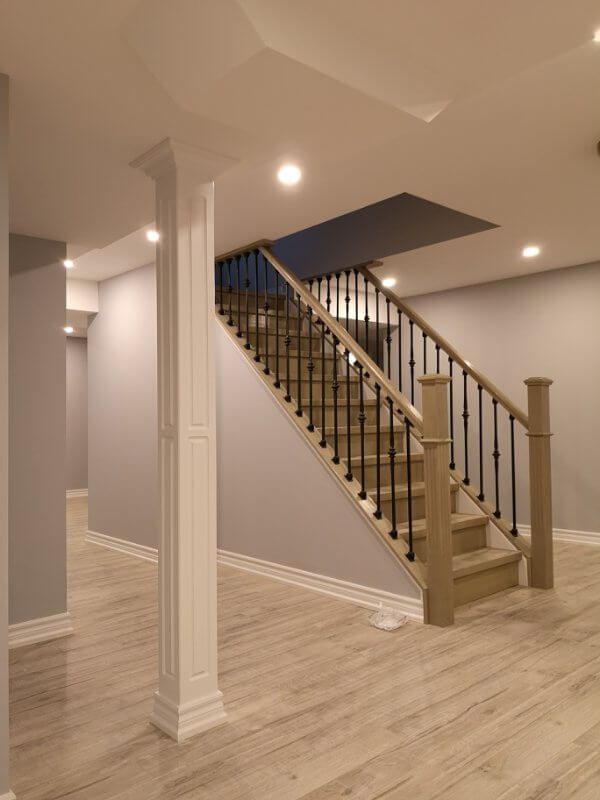 This finished basement renovation in Markham showcases a bright open-concept layout with new flooring, upgraded staircase, modern columns, and recessed lighting. Completed by a trusted Toronto renovation company, the project transforms the basement into a spacious and comfortable living area, enhancing both property value and everyday functionality.