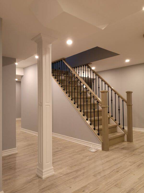 This finished basement renovation in Markham showcases a bright open-concept layout with new flooring, upgraded staircase, modern columns, and recessed lighting. Completed by a trusted Toronto renovation company, the project transforms the basement into a spacious and comfortable living area, enhancing both property value and everyday functionality.