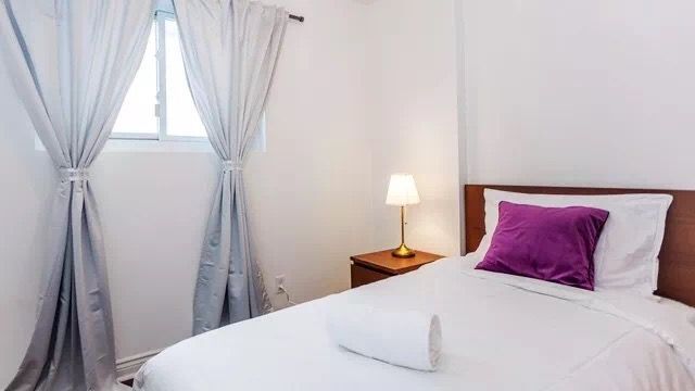 This Toronto interior renovation features a bright and cozy bedroom with minimalist styling. The space includes a comfortable bed setup, soft lighting, and a functional workspace corner, creating a relaxing and practical environment. Neutral tones and clean lines enhance the overall comfort, making it an ideal modern bedroom design for everyday living.