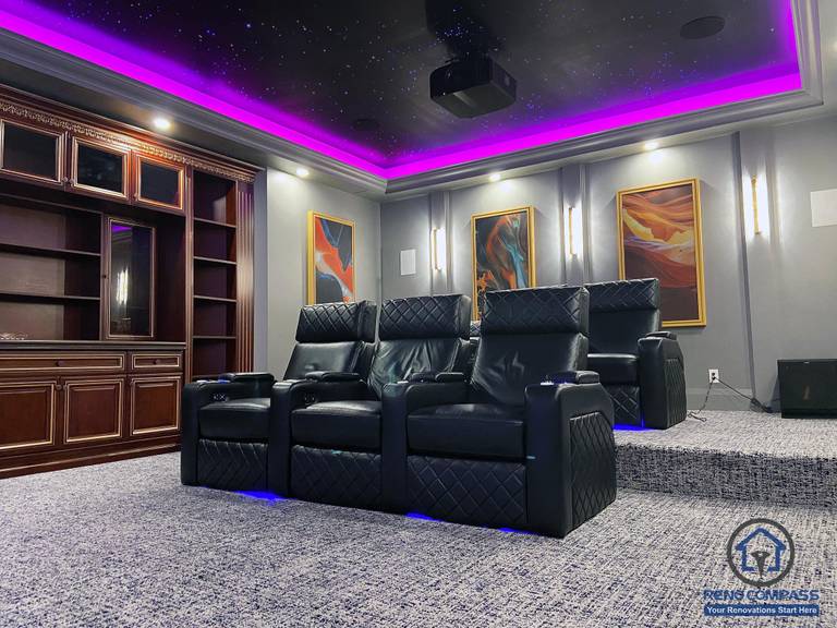 Full view of a custom home theatre renovation in Aurora featuring tiered seating, star ceiling, ambient LED lighting, and a large projection screen for immersive entertainment.