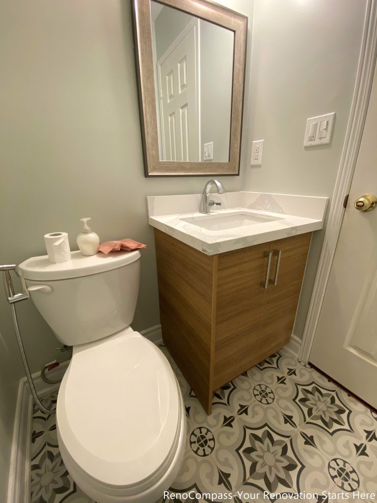 This Mississauga bathroom renovation features a compact vanity with warm wood finishes, a clean white countertop, and classic patterned floor tiles. The layout was designed to maximize functionality in a small space while maintaining a clean, modern look. Neutral wall colors and simple fixtures help keep the bathroom bright and practical for daily use.
City: Mississauga · Toronto contractor: Reno Compass