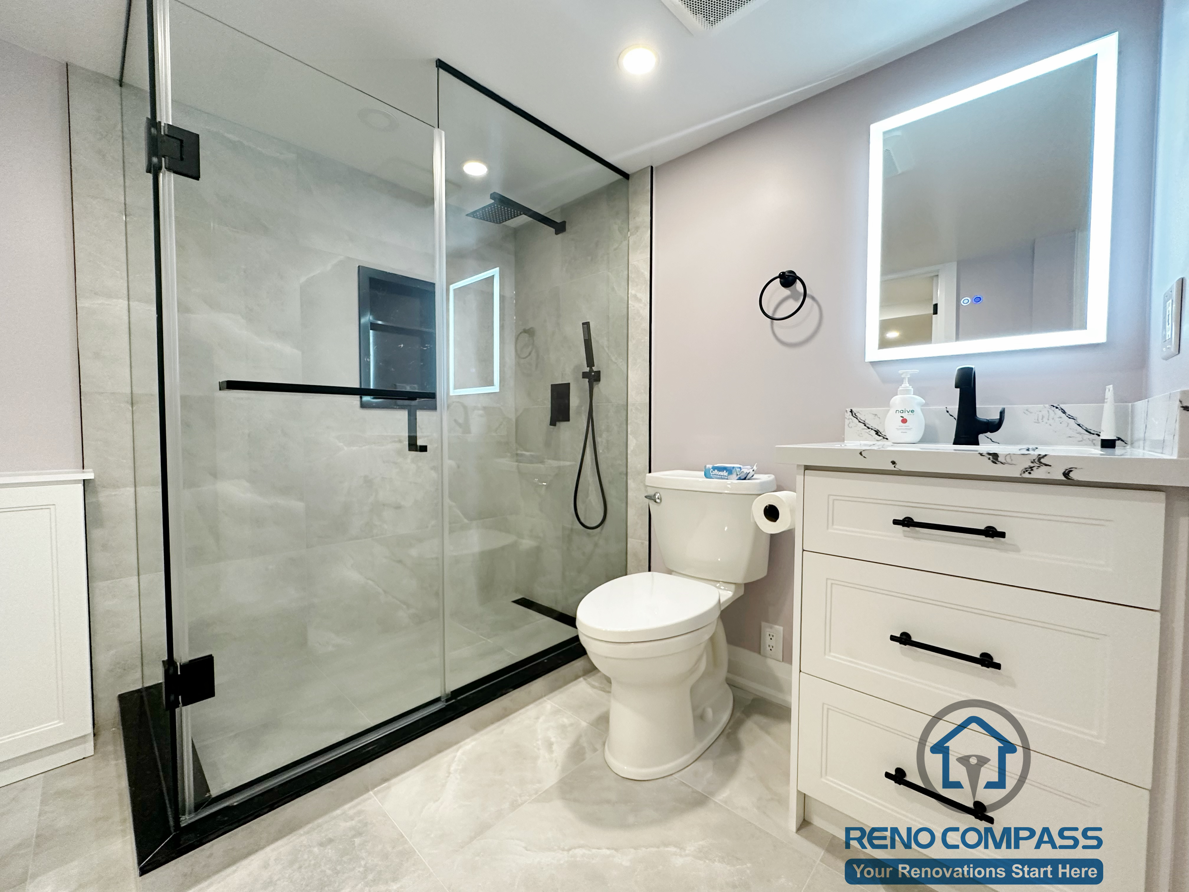 his Mississauga bathroom renovation features a full glass shower enclosure, modern tile finishes, and a custom vanity with integrated storage. The design improves functionality, enhances visual openness, and delivers a clean, contemporary bathroom layout for everyday use.