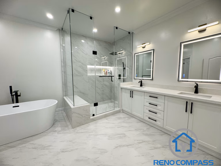 This modern Vaughan bathroom renovation features a clean and elegant layout with a double vanity, quartz countertop, and sleek black fixtures. A frameless glass shower with large-format marble-look tiles creates a spacious and luxurious feel, while the freestanding bathtub adds a spa-like touch. Completed by a professional Toronto Renovation Company, this bathroom design focuses on functionality, durability, and timeless modern aesthetics.