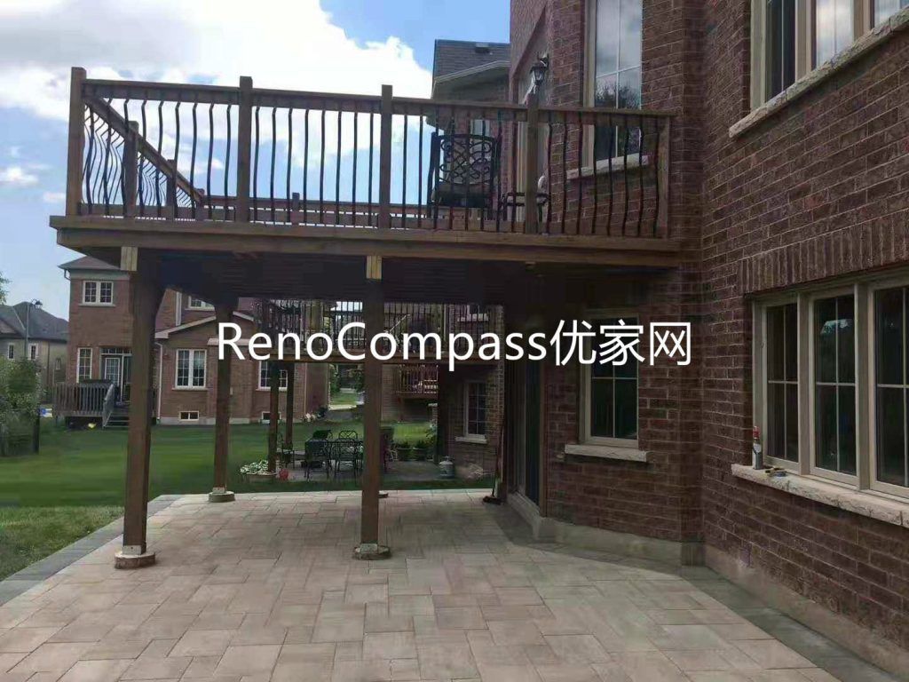 Custom backyard renovation in Richmond Hill featuring elevated wood deck construction with modern railing and professionally installed interlocking stone patio underneath. This outdoor upgrade improves functionality, durability, and visual appeal, creating a versatile multi-level outdoor living and entertaining space.
