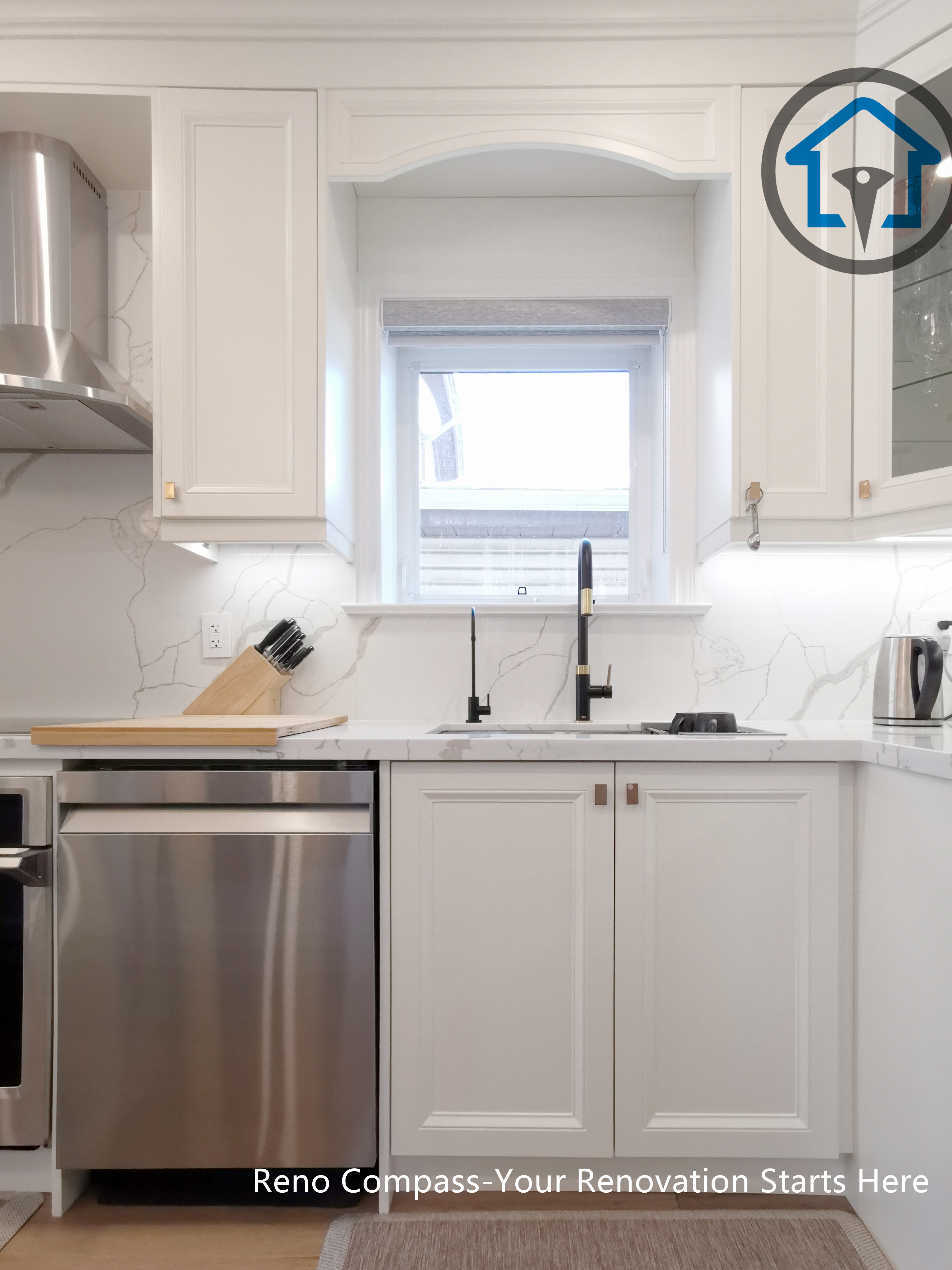 This image showcases the symmetrical sink wall design in a North York interior renovation, featuring custom white cabinetry, quartz countertops, and a centrally positioned window that brings in natural light. The balanced cabinet proportions and clean millwork details create a timeless and orderly kitchen layout. A stainless steel dishwasher, modern range hood, and minimalist black faucet add contrast while maintaining a cohesive design language. Completed by a Toronto renovation company, this kitchen renovation reflects precise craftsmanship, thoughtful detailing, and a strong focus on functionality and visual balance.