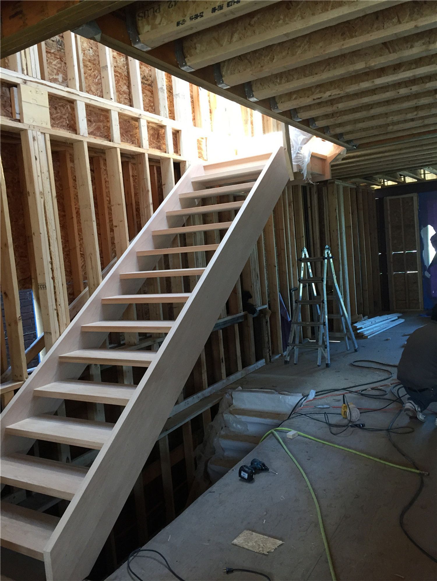 This image shows a newly installed hardwood staircase during a basement renovation project in Toronto. The staircase structure is carefully built with evenly spaced treads and strong side framing to ensure safety, durability, and proper access between levels. Installed within a framed construction environment, this stair system demonstrates precise carpentry and structural planning. As a professional Toronto Renovation Company, Reno Compass Inc. provides high-quality staircase installation and renovation services for residential projects across Toronto and the Greater Toronto Area.