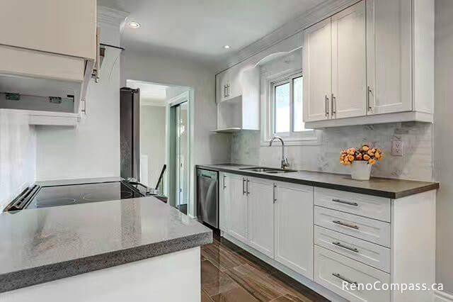 This bright and modern kitchen renovation by Reno Compass features custom white cabinetry, durable quartz countertops, and a clean contemporary layout designed for everyday functionality. The upgraded lighting, efficient storage solutions, and open workspace create a fresh and welcoming cooking environment. As a professional Toronto renovation contractor, Reno Compass delivers high-quality kitchen remodeling with attention to detail, durable materials, and timeless design for GTA homeowners.