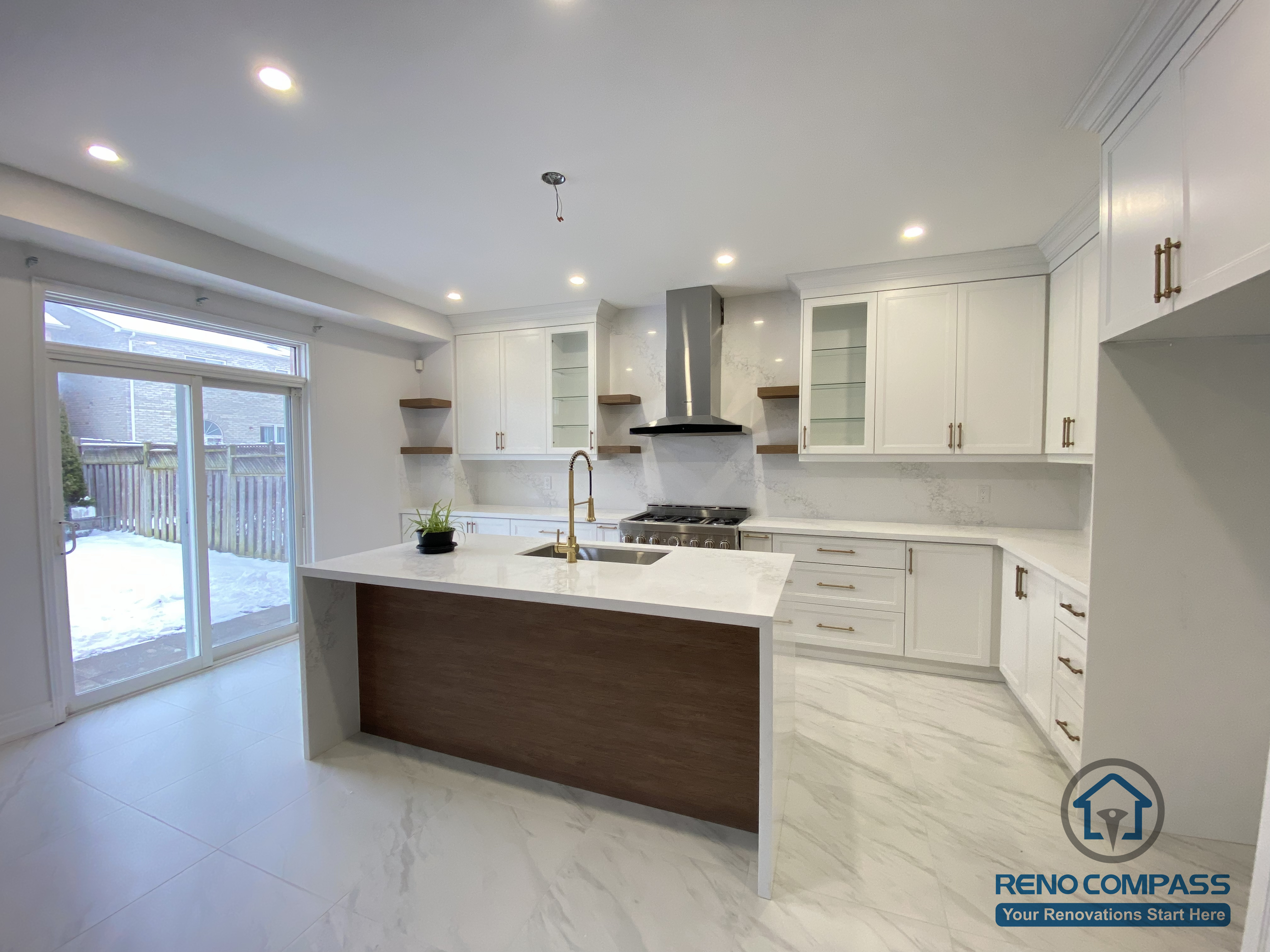 This Markham kitchen renovation features a spacious open-concept layout centered around a large waterfall island designed for cooking, dining, and everyday family use. Custom white shaker cabinetry provides ample storage while maintaining a clean, timeless look, complemented by quartz countertops and a modern stainless steel range hood. Full-height cabinetry, integrated lighting, and marble-look porcelain flooring enhance both functionality and visual continuity. Completed by a professional Toronto renovation company, this kitchen upgrade balances practicality, proportion, and long-term residential value.