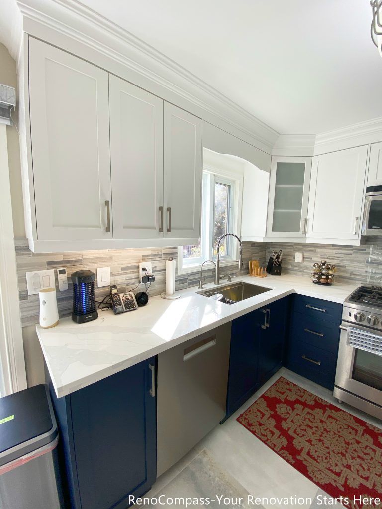 A close-up view of the kitchen countertop and sink area from a Newmarket interior renovation, highlighting quartz surfaces, custom cabinetry, tiled backsplash, and a practical workspace designed by a Toronto renovation company.
