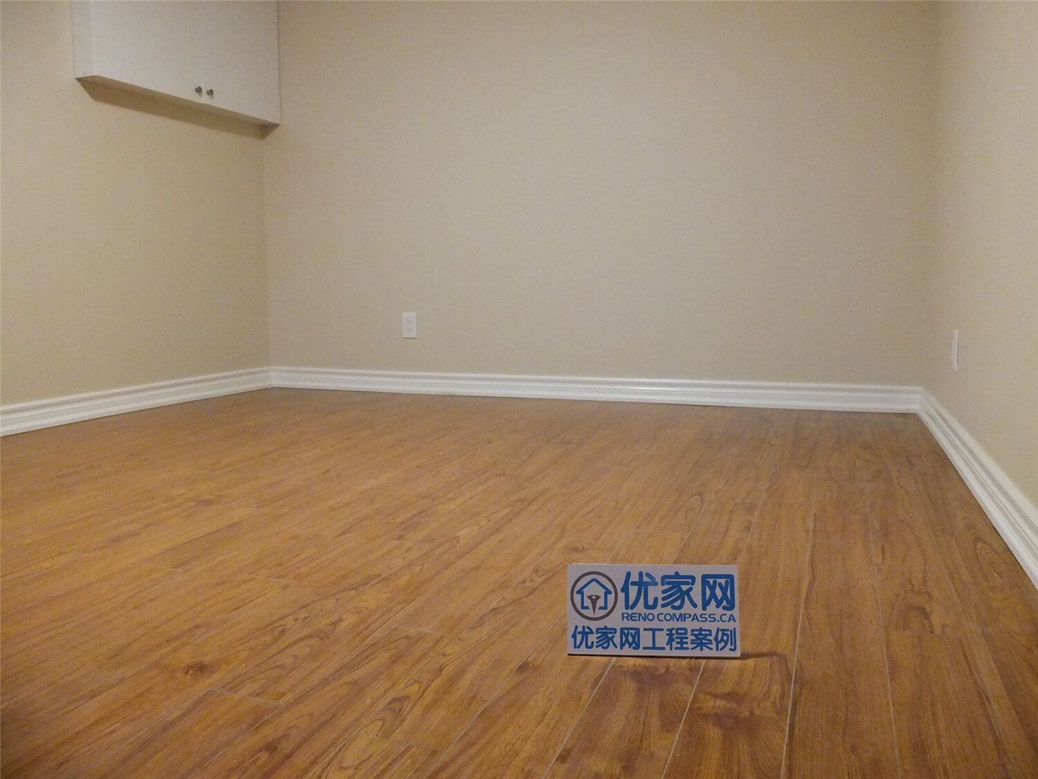 This Markham basement renovation project features newly finished walls, fresh interior painting, and durable laminate flooring installation. The clean wall finish, neutral paint tones, and wood-style flooring create a bright, comfortable living space suitable for a family recreation room or additional living area. Careful detailing around the baseboards and wall edges ensures a smooth and polished appearance throughout the basement interior.