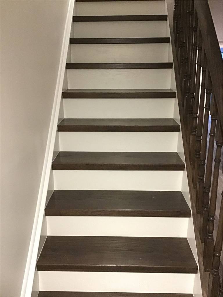This Richmond Hill basement renovation includes an upgraded staircase featuring dark wood treads paired with clean white risers for a modern contrast look. The sturdy handrail and refined finish enhance both safety and aesthetics, making the transition between floors more stylish and functional. A great example of basement stair renovation in Richmond Hill.