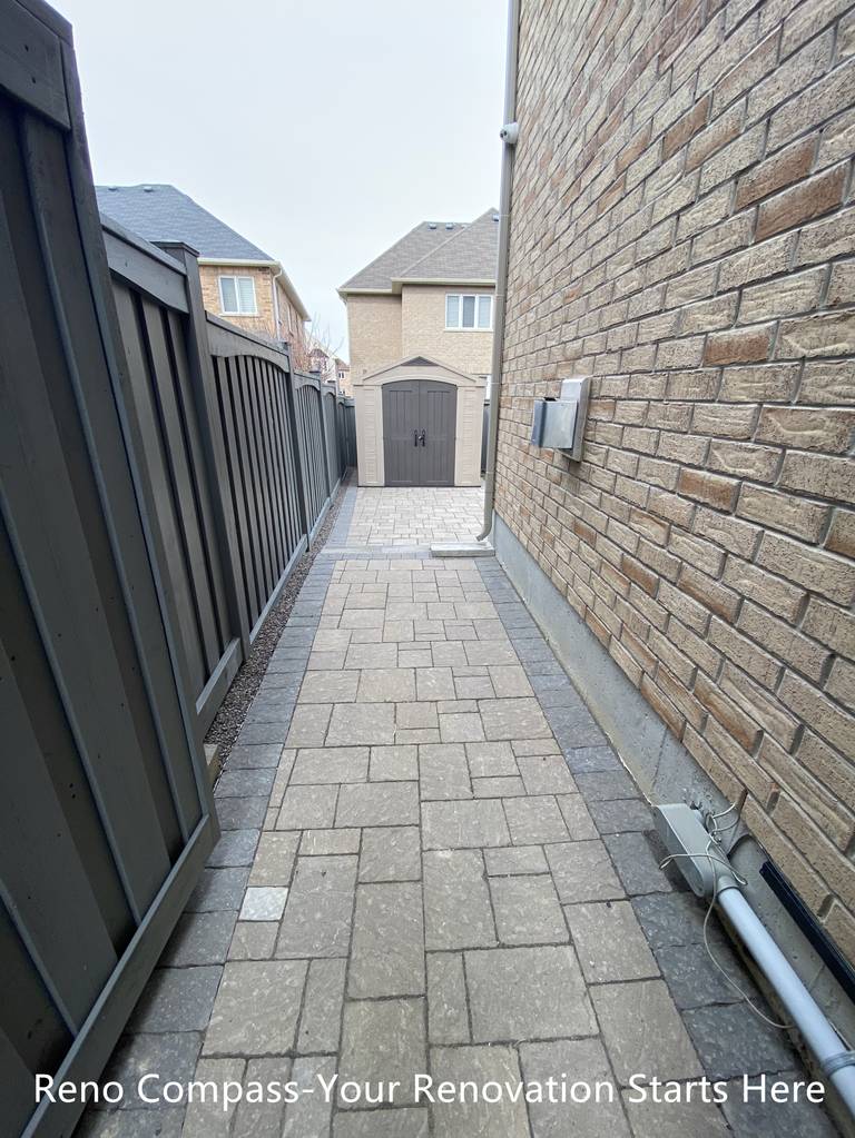 Side yard interlocking walkway renovation in Newmarket featuring a narrow passage paved with durable concrete pavers and clean edge restraints. The upgraded walkway improves drainage, accessibility, and long-term maintenance while creating a neat and functional transition between front and backyard spaces. Completed by a professional Toronto renovation company specializing in residential exterior renovations.