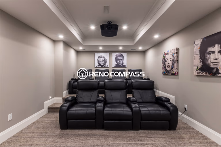 Luxury basement home theater renovation in Toronto featuring a custom cinema room with tiered seating, leather recliners, recessed lighting, and ceiling-mounted projector system. This professionally designed entertainment space was completed by a trusted Toronto renovation company, Reno Compass Inc., creating a premium movie experience at home.