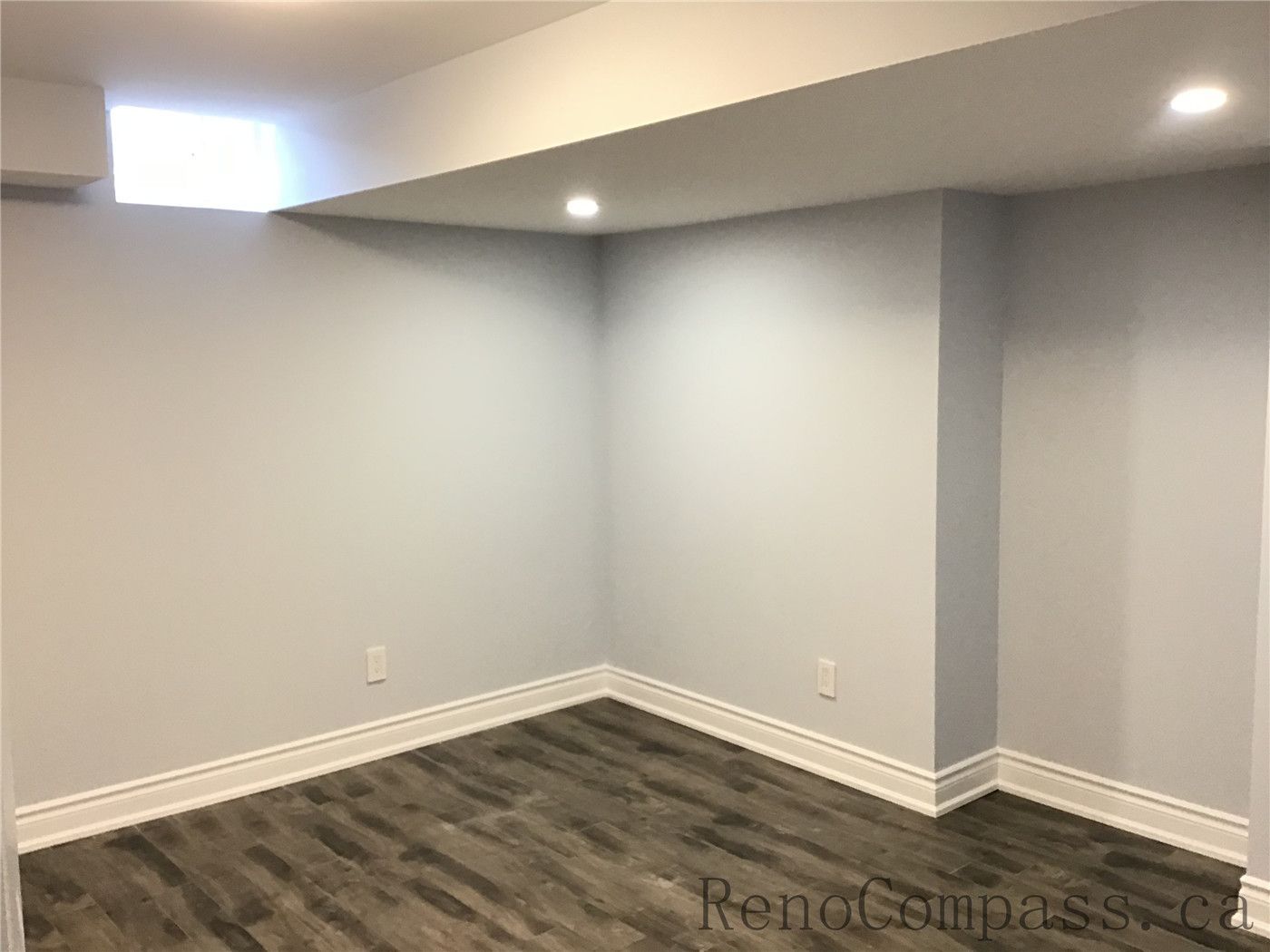 Bright and newly finished basement space in Richmond Hill featuring neutral wall tones, recessed pot lighting, upgraded baseboards, and durable wood-look vinyl flooring. This flexible area can serve as a bedroom, office, or gym, highlighting the clean craftsmanship and thoughtful layout of a professionally completed basement renovation by a trusted Toronto Renovation Company.