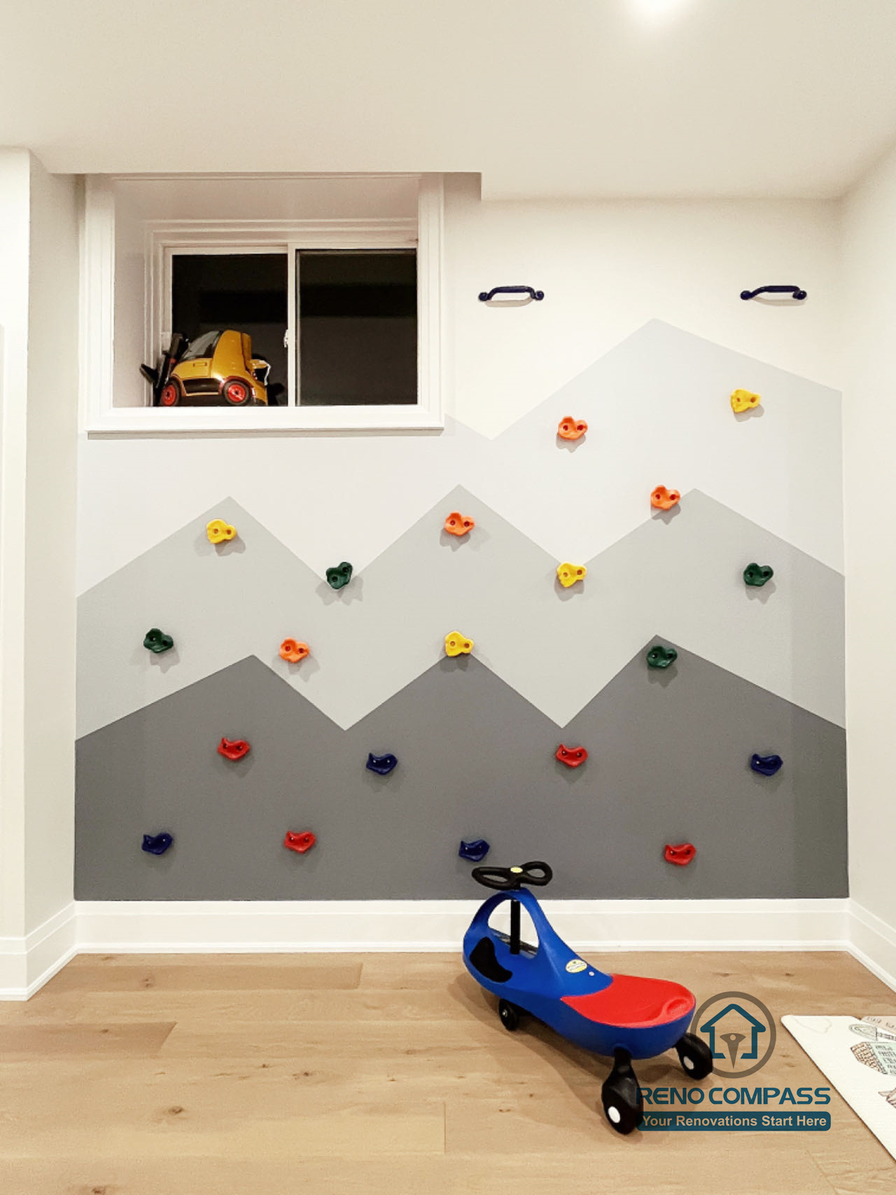 Basement playroom renovation in Newmarket featuring a custom climbing wall, soft play flooring, built-in storage, and an open layout designed for children’s activity and creative play.