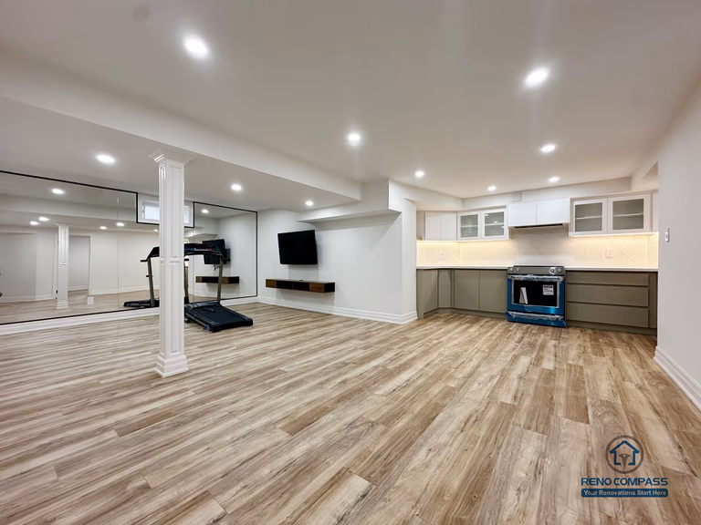 his image presents a completed open-concept basement renovation in Pickering, highlighting the overall spatial layout and flow between the kitchen, living area, and adjacent rooms. The design emphasizes flexibility and usability, with consistent flooring, recessed ceiling lighting, and clear circulation throughout the space. The kitchen is seamlessly integrated into the open layout, allowing the basement to function as an extension of the main living area. Neutral finishes and balanced proportions contribute to a bright, cohesive environment suitable for everyday living, entertainment, or multi-purpose use.
Location: Pickering · Toronto Contractor: Reno Compass