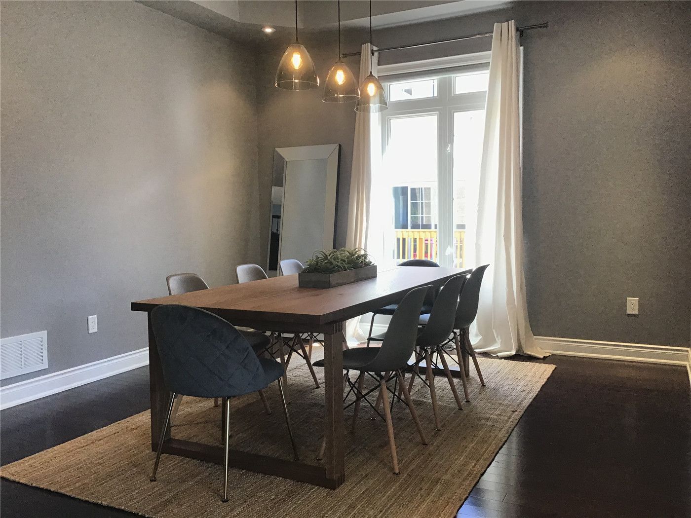This Markham full home renovation features a stylish dining area with a modern open-concept layout, warm pendant lighting, and rich hardwood flooring. The space is enhanced by large windows and soft neutral tones, creating a bright and inviting environment for everyday living and entertaining. Completed by a trusted Toronto Renovation Company, this project highlights a perfect balance of comfort and contemporary design.