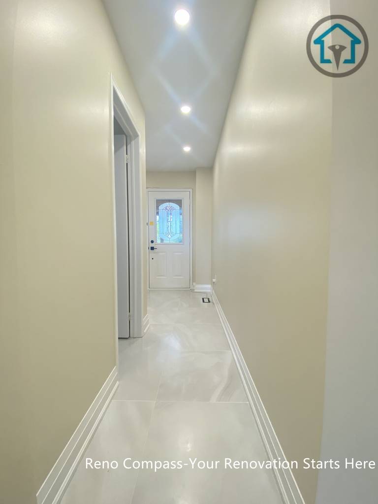 Hallway view from a completed interior renovation project in Vaughan, showing a clean and streamlined circulation space by Reno Compass.