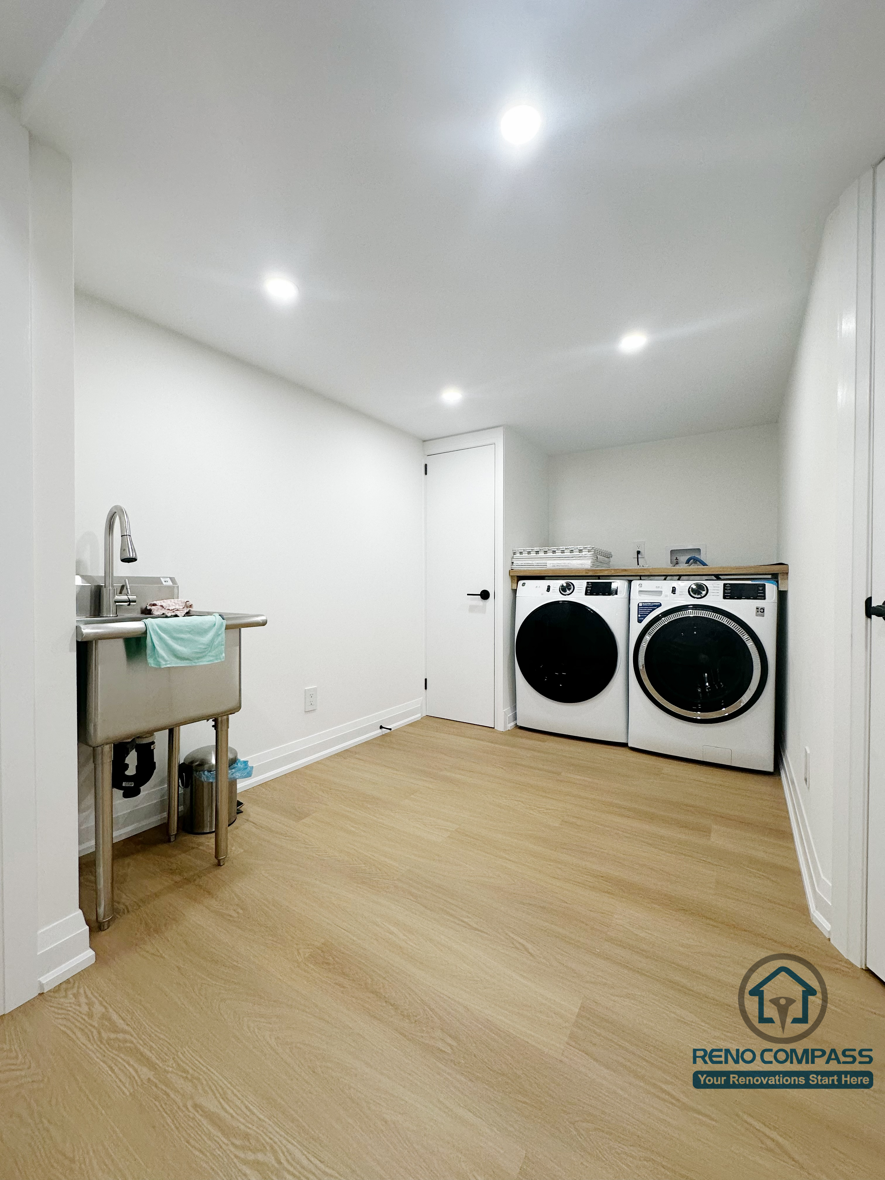 Finished basement laundry and utility space in Markham featuring recessed lighting, moisture-resistant flooring, and a clean, functional layout. Designed for long-term durability and everyday convenience within a full basement renovation project.
