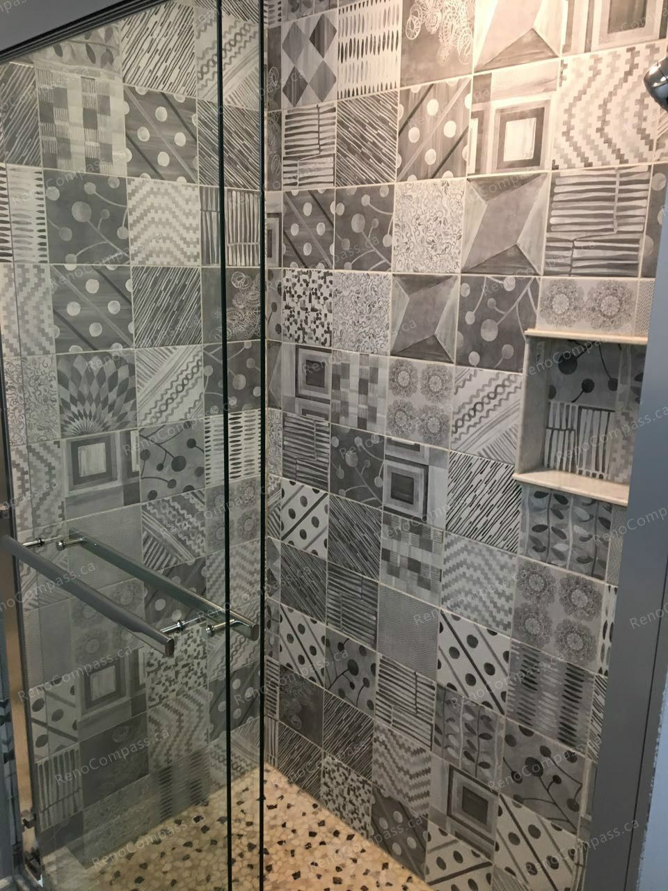 This Markham interior renovation features a custom glass-enclosed shower with stylish patterned tile walls and durable mosaic flooring. The modern design adds visual texture and character while maintaining easy maintenance and functionality. Completed by a professional Toronto renovation company, this bathroom upgrade delivers a contemporary spa-like feel with quality craftsmanship and detailed finishing.
