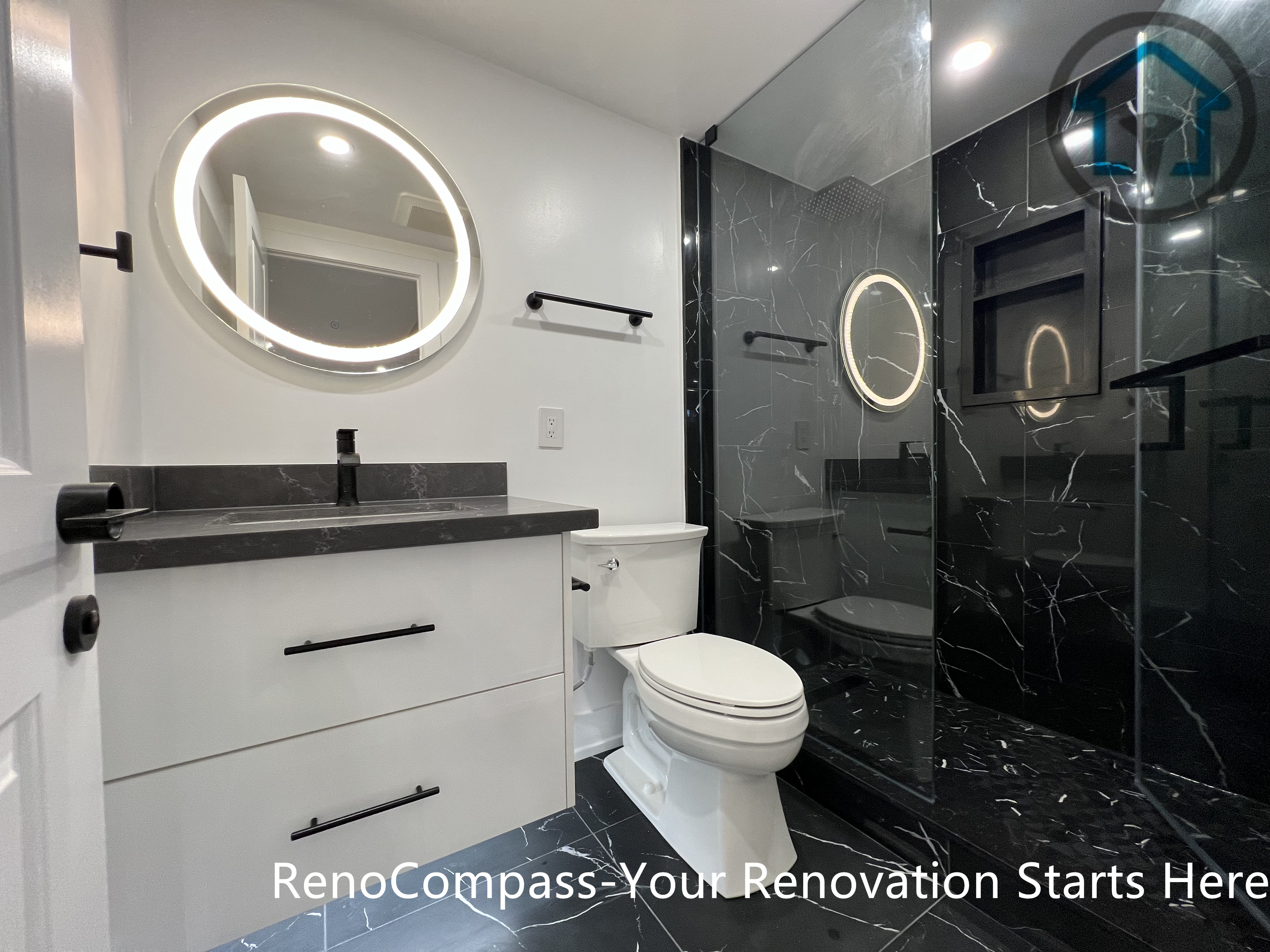 This Vaughan basement renovation features a contemporary full bathroom with a glass-enclosed shower, dark marble-look tiles, a floating vanity, and an LED-backlit mirror. The compact yet efficient layout maximizes comfort and durability while maintaining a clean, modern aesthetic suitable for basement environments. Completed by a Toronto renovation company, this basement bathroom renovation reflects careful material selection and functional space planning.
