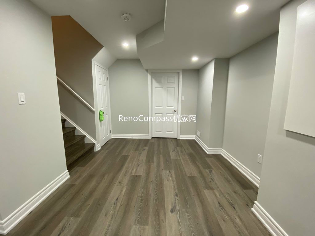 Stylish basement flooring renovation in Richmond Hill with durable laminate planks and elegant white trim. Reno Compass delivered a long-lasting, modern look perfect for daily family living.