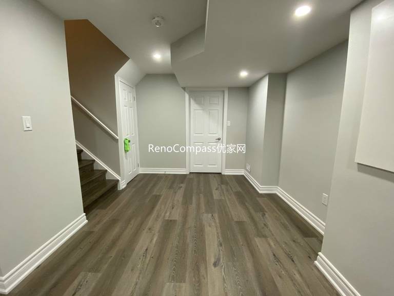 Stylish basement flooring renovation in Richmond Hill with durable laminate planks and elegant white trim. Reno Compass delivered a long-lasting, modern look perfect for daily family living.