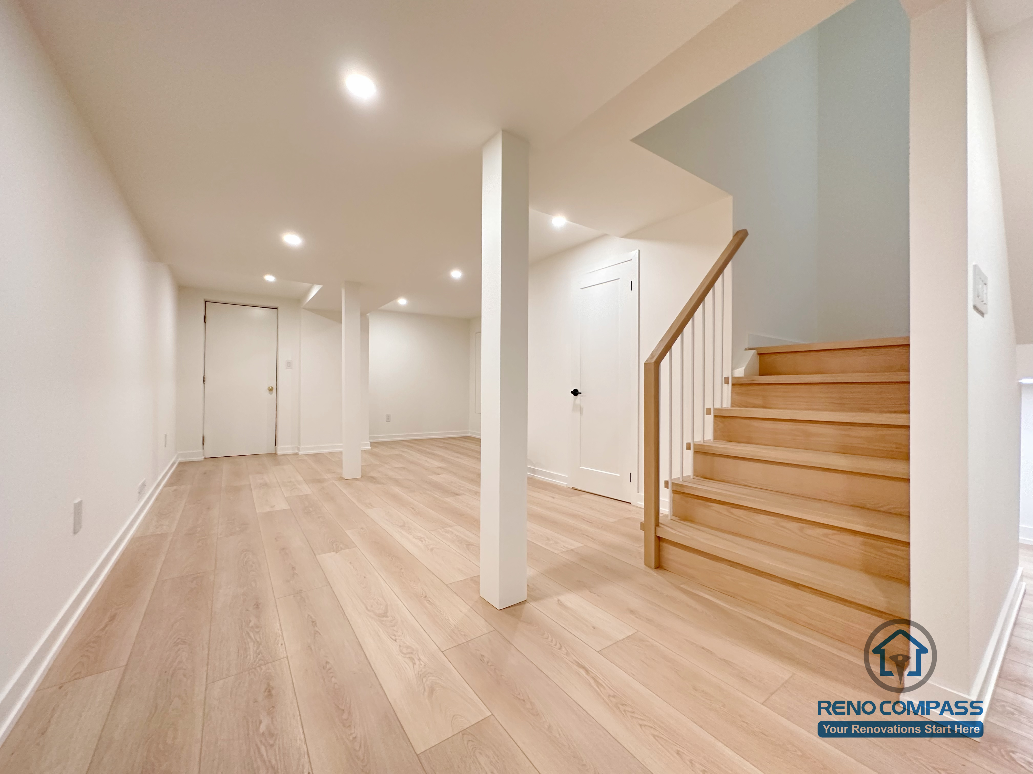 This Markham basement renovation features a clean, open-concept layout with wide-plank flooring, recessed ceiling lights, and a solid wood staircase that creates a seamless connection between levels. Structural columns are carefully integrated to maintain openness while ensuring long-term stability. Designed and completed by a professional Toronto renovation company, this basement space is ideal for a family living area, entertainment zone, or flexible multi-purpose use.