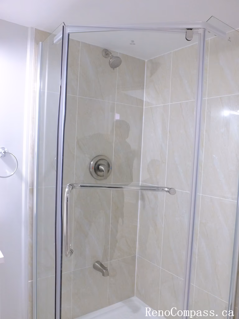 Elegant Richmond Hill basement bathroom remodel featuring bright tiles, glass shower, and clean modern finishes by Reno Compass Inc., trusted Toronto Renovation Company.