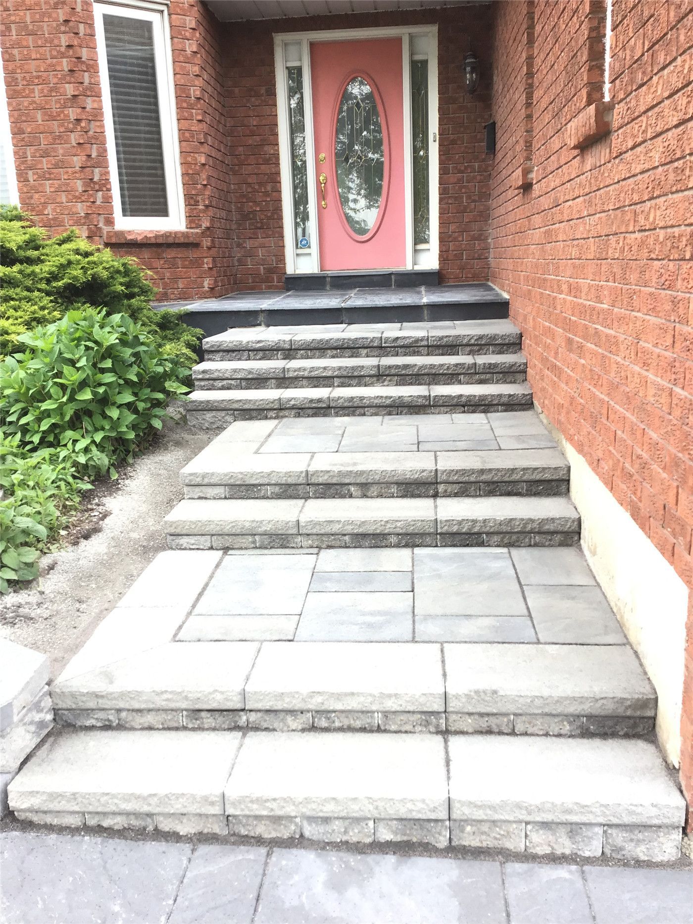 This Mississauga landscaping renovation features a professionally installed interlocking driveway with a modern grey tone and clean border design. The project enhances curb appeal while ensuring durability, proper drainage, and long-term low maintenance.