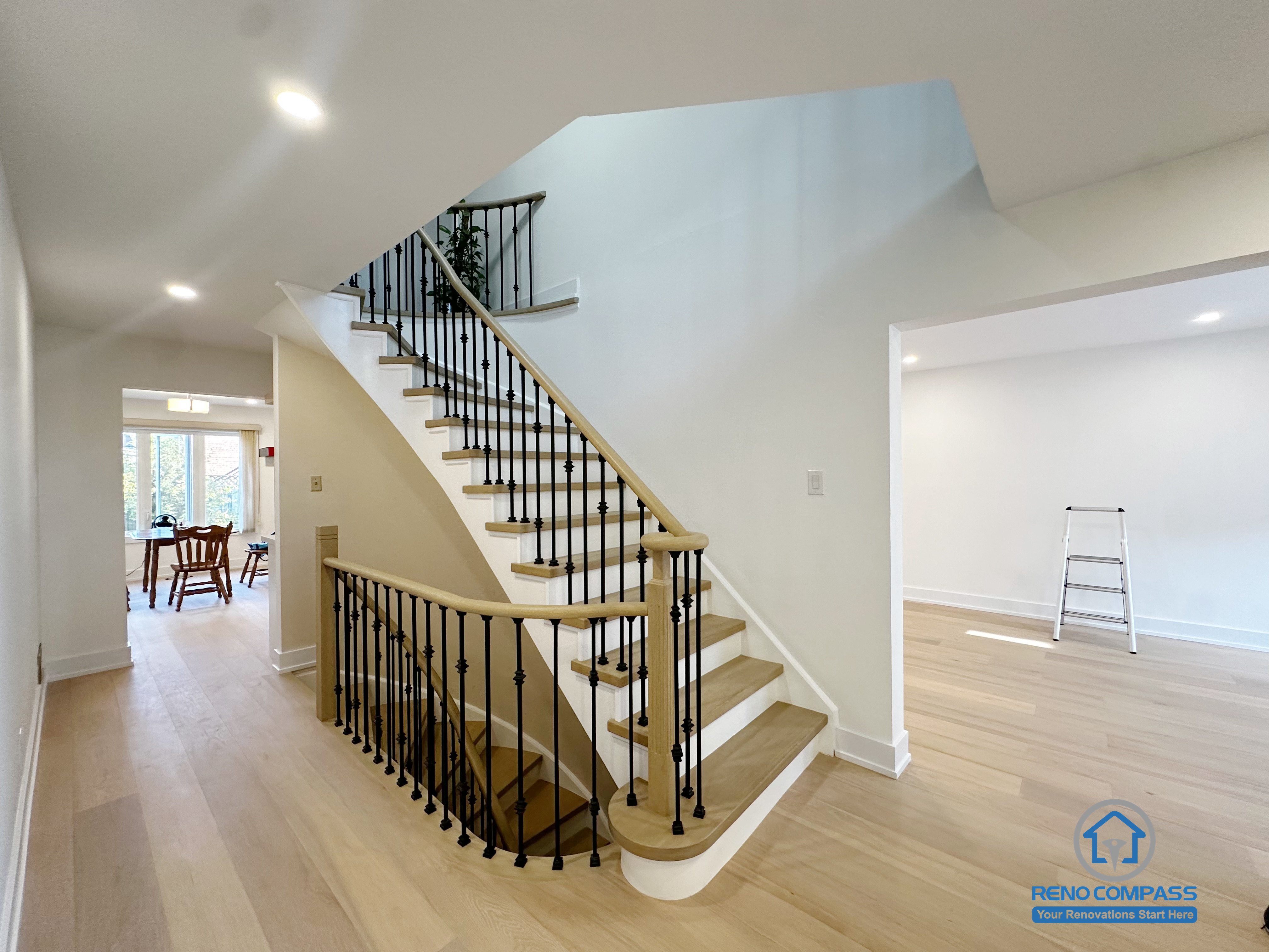 This image features a completed interior staircase renovation in Richmond Hill, showcasing an open layout that enhances circulation and visual continuity between levels. The staircase is designed with wood treads and black metal balusters, creating a balanced contrast that complements the surrounding interior finishes. Open sightlines and consistent flooring help maintain a bright and connected living environment, while the stair layout supports smooth movement between adjacent living spaces. The overall design emphasizes structural clarity, everyday functionality, and long-term residential use.
Location: Richmond Hill · Toronto Contractor: Reno Compass