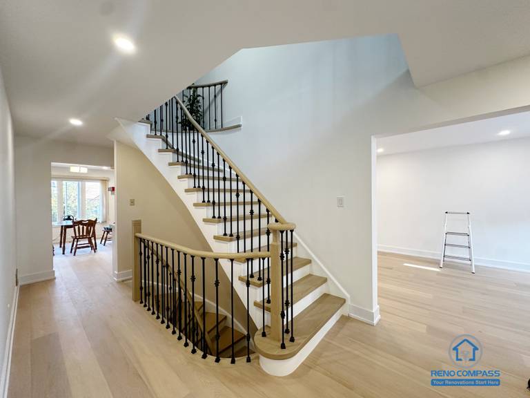 This image features a completed interior staircase renovation in Richmond Hill, showcasing an open layout that enhances circulation and visual continuity between levels. The staircase is designed with wood treads and black metal balusters, creating a balanced contrast that complements the surrounding interior finishes. Open sightlines and consistent flooring help maintain a bright and connected living environment, while the stair layout supports smooth movement between adjacent living spaces. The overall design emphasizes structural clarity, everyday functionality, and long-term residential use.
Location: Richmond Hill · Toronto Contractor: Reno Compass