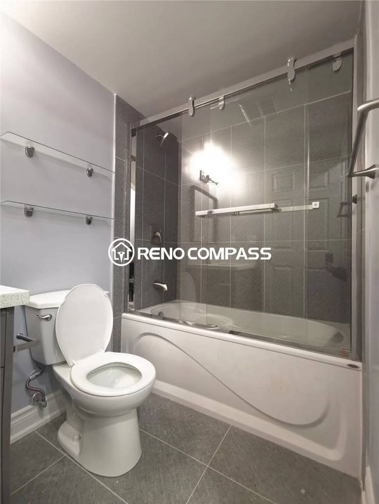 This Richmond Hill condo bathroom renovation features a clean and modern upgrade with a sliding glass bathtub shower enclosure, grey wall and floor tiles, and updated bathroom fixtures. The renovation focuses on improving functionality, lighting, and overall comfort while maximizing limited condo space. Completed by a professional Toronto renovation team, this bathroom transformation delivers a practical and contemporary design ideal for everyday use.