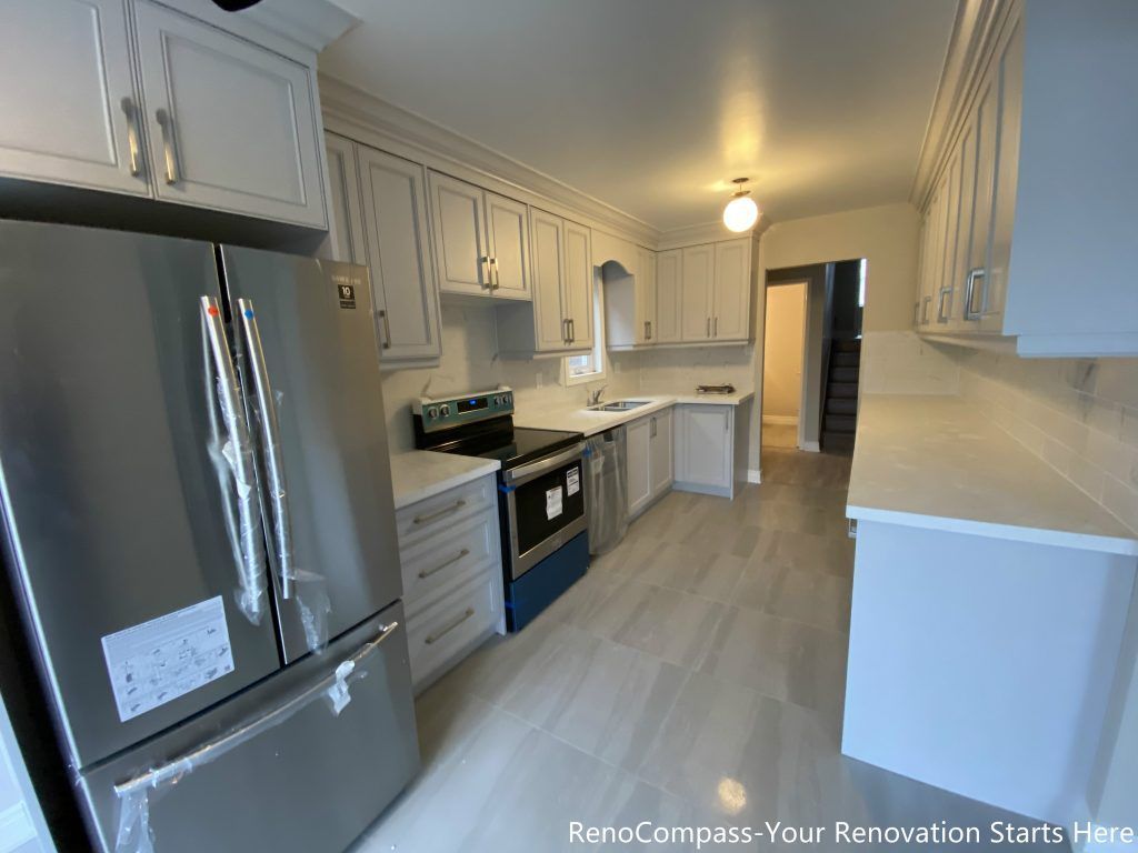 This Mississauga interior renovation showcases a modern U-shaped kitchen layout featuring custom shaker-style cabinetry, quartz countertops, and stainless steel appliances. The design emphasizes efficient workflow, generous storage, and a clean visual balance. Soft neutral tones and full-height cabinetry enhance brightness and functionality, making this kitchen renovation ideal for long-term everyday living.