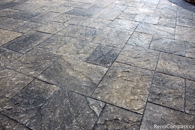 A close-up view of the interlocking stone surface in this Markham landscaping project highlights the natural texture, precise cuts, and tight joint alignment. The carefully selected paving stones create a durable, slip-resistant, and visually cohesive outdoor surface. Installed by a Toronto renovation company, this garden paving solution demonstrates attention to craftsmanship, material quality, and long-term performance.