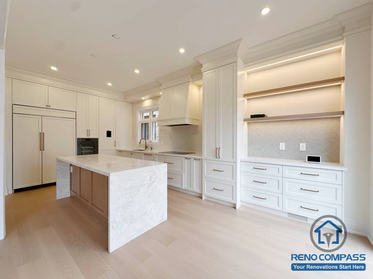 Close-up of a waterfall kitchen island in a Toronto home renovation, highlighting stone texture, clean edges, and functional workspace design.