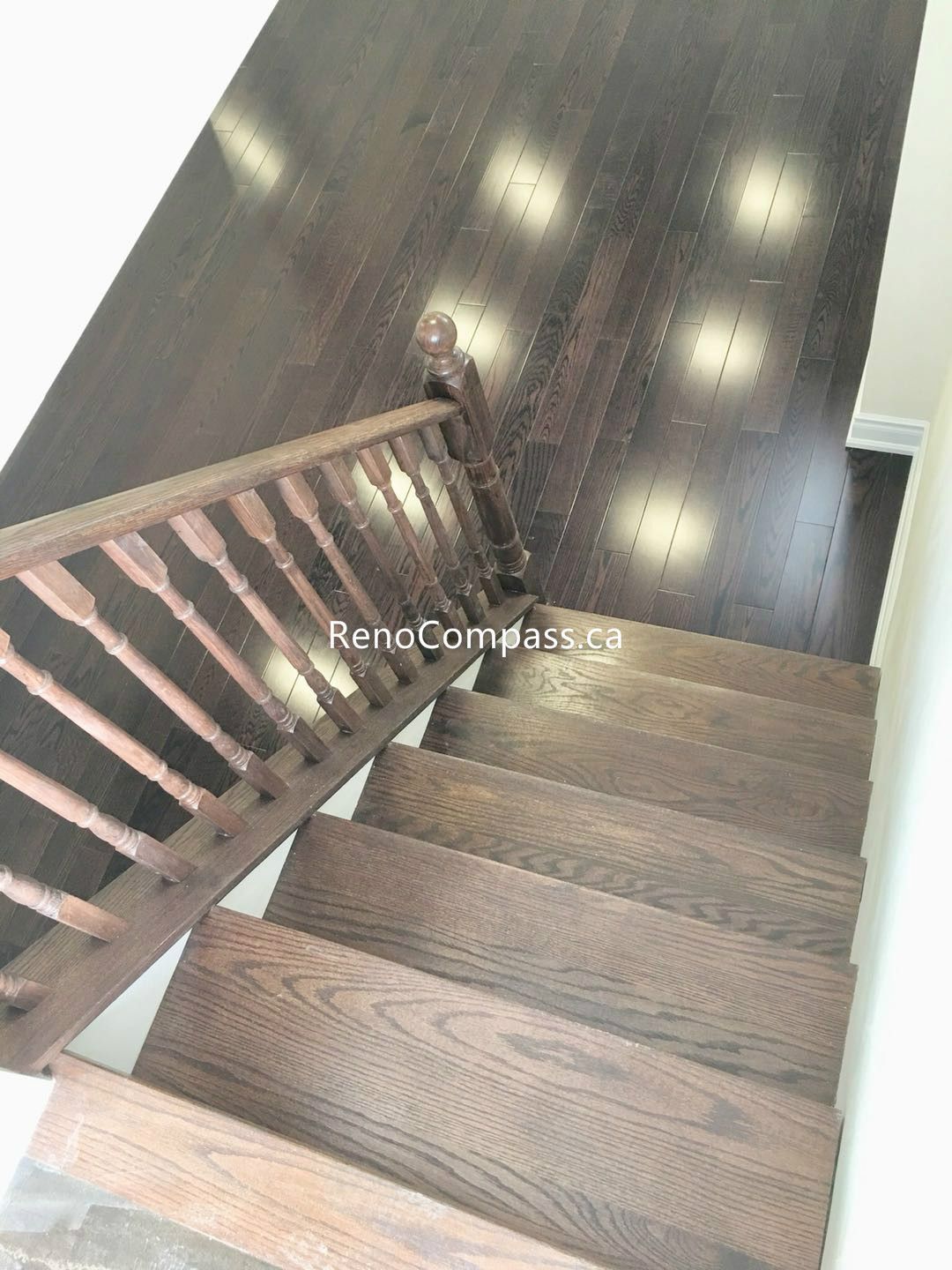 This Toronto basement renovation features newly installed hardwood stairs and matching engineered flooring, creating a clean and modern transition between levels. The upgraded staircase railing and rich wood tones enhance durability, safety, and overall home value. Completed by a professional Toronto renovation company, this project highlights quality craftsmanship and functional design for contemporary basement living spaces.