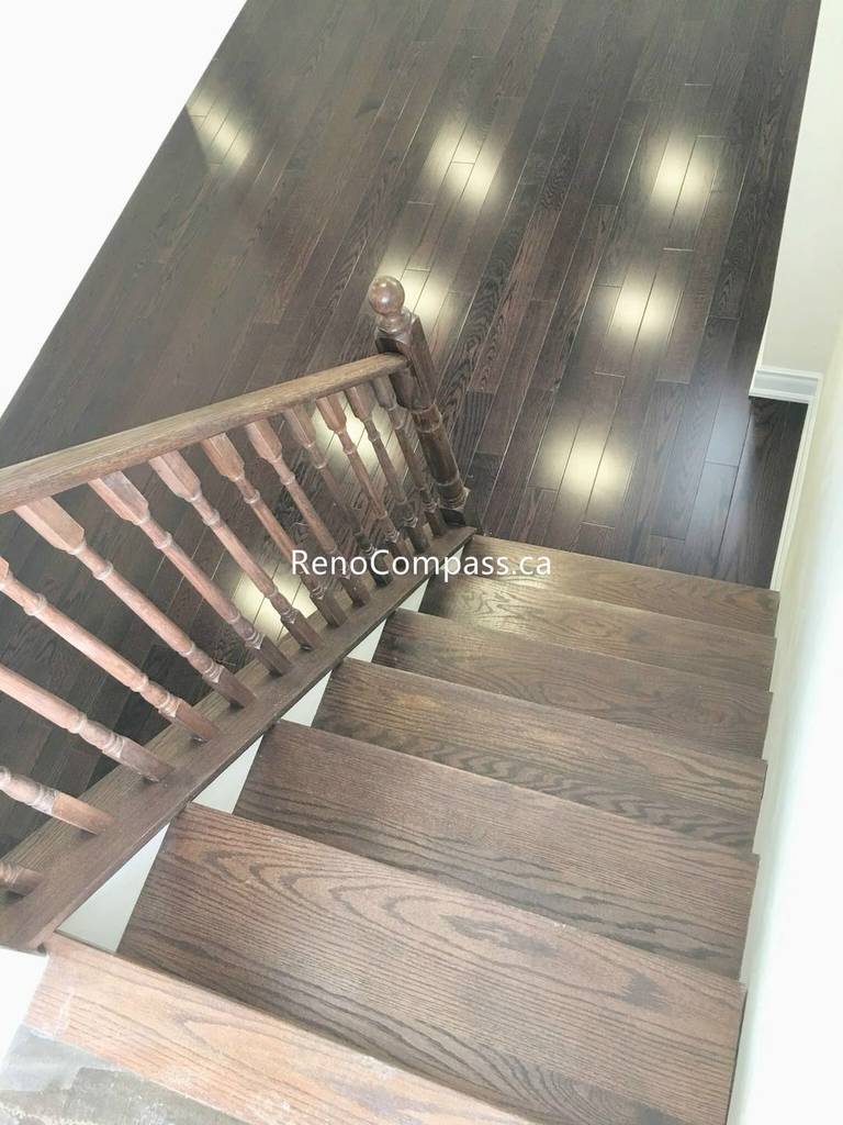 This Toronto basement renovation features newly installed hardwood stairs and matching engineered flooring, creating a clean and modern transition between levels. The upgraded staircase railing and rich wood tones enhance durability, safety, and overall home value. Completed by a professional Toronto renovation company, this project highlights quality craftsmanship and functional design for contemporary basement living spaces.