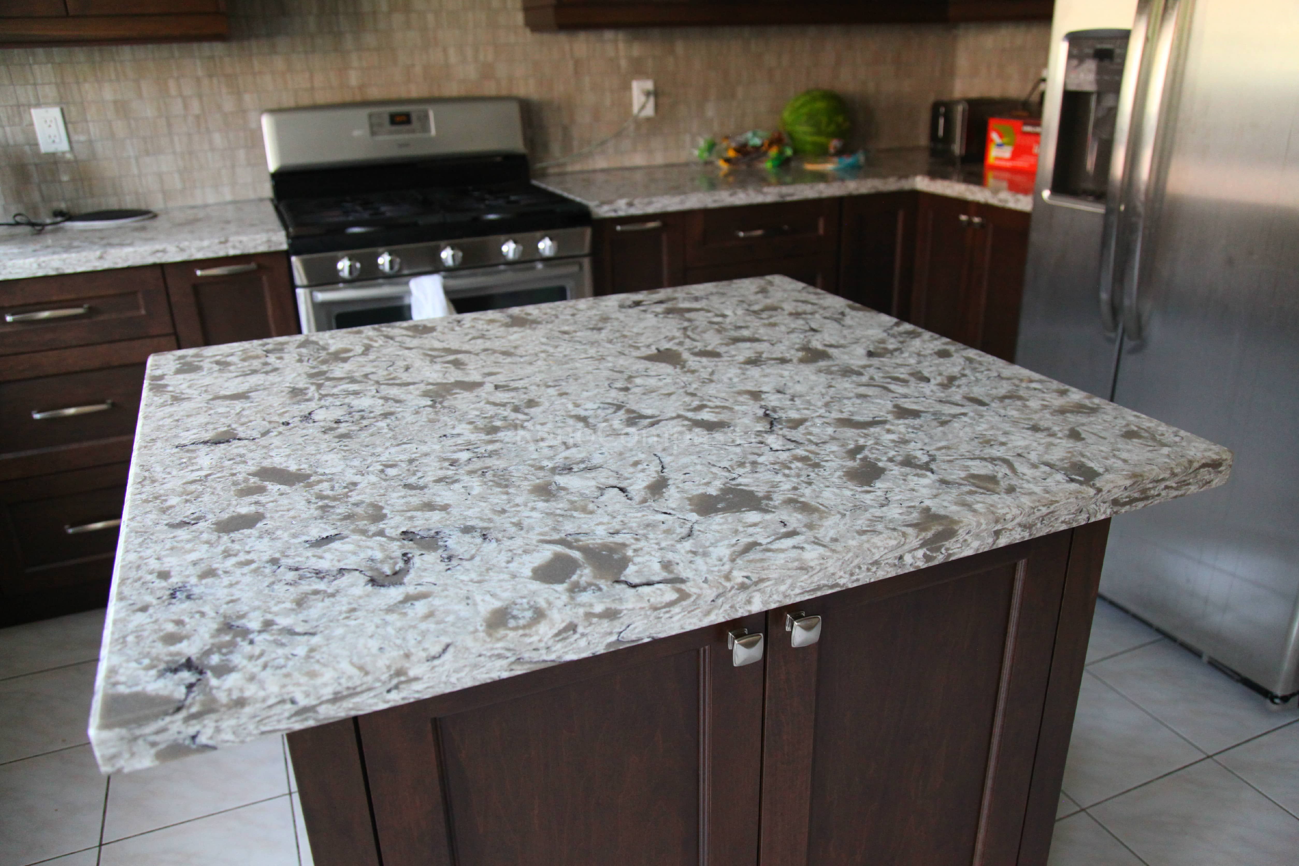 This Markham kitchen renovation features rich dark wood cabinetry, a custom quartz island, and modern stainless steel appliances, creating a warm and functional cooking space. Designed and completed by a professional Toronto renovation company, the layout enhances storage, workflow, and overall visual appeal while maintaining a timeless and elegant kitchen design.