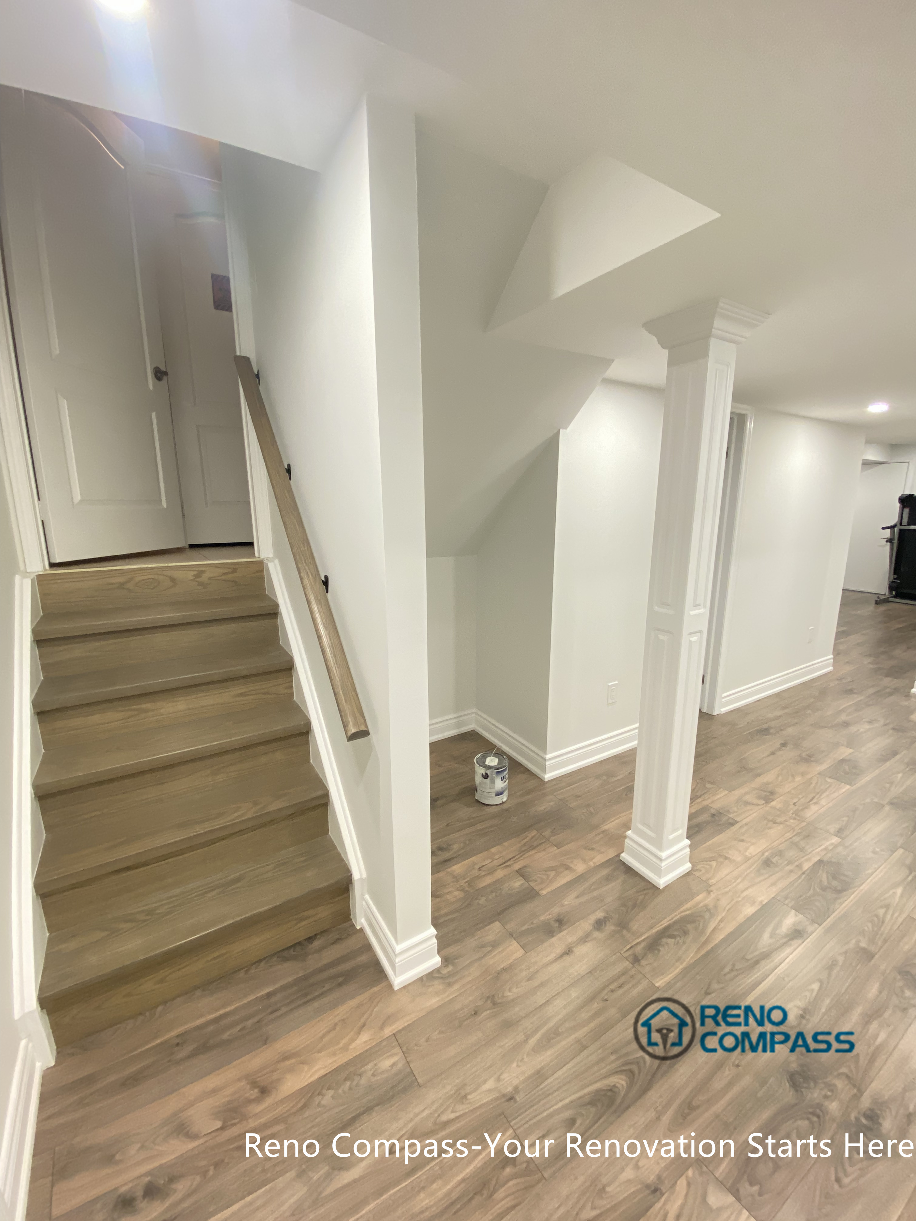 A renovated basement staircase and hallway in Aurora, designed to create a smooth transition between levels. Neutral finishes and streamlined detailing improve safety, brightness, and overall visual continuity throughout the basement renovation.