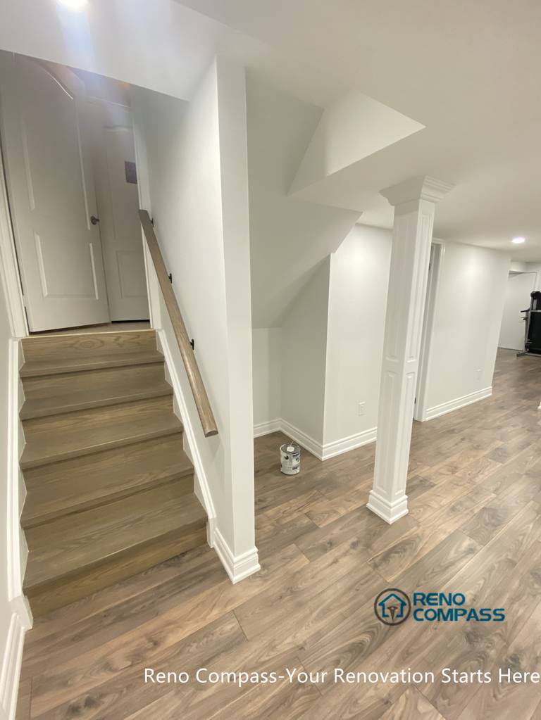 A renovated basement staircase and hallway in Aurora, designed to create a smooth transition between levels. Neutral finishes and streamlined detailing improve safety, brightness, and overall visual continuity throughout the basement renovation.