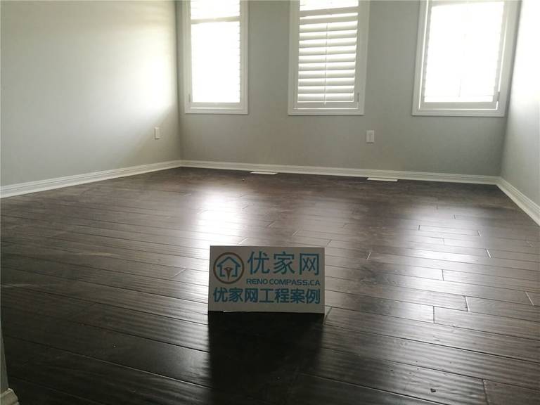 This Scarborough flooring replacement project features newly installed dark hardwood flooring that enhances the room’s depth and modern appeal. The rich wood tone contrasts beautifully with the light grey walls and white baseboards, creating a clean and contemporary atmosphere. Installed by a professional Toronto Renovation Company, the flooring was precisely aligned for a seamless finish and long-term durability.