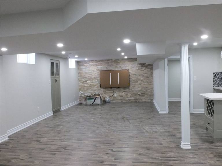 This Scarborough basement renovation project features a modern open-concept layout designed to maximize space, comfort, and functionality. The newly finished basement includes premium moisture-resistant flooring, recessed pot lights for bright and even illumination, and a spacious entertainment area perfect for family gatherings or rental potential. A custom-built bar and storage area enhance both convenience and style, creating a versatile living and leisure space. Completed by a professional Toronto basement renovation company, the project focuses on clean finishes, durable materials, and long-term property value improvement. Contractor: Reno Compass Inc.