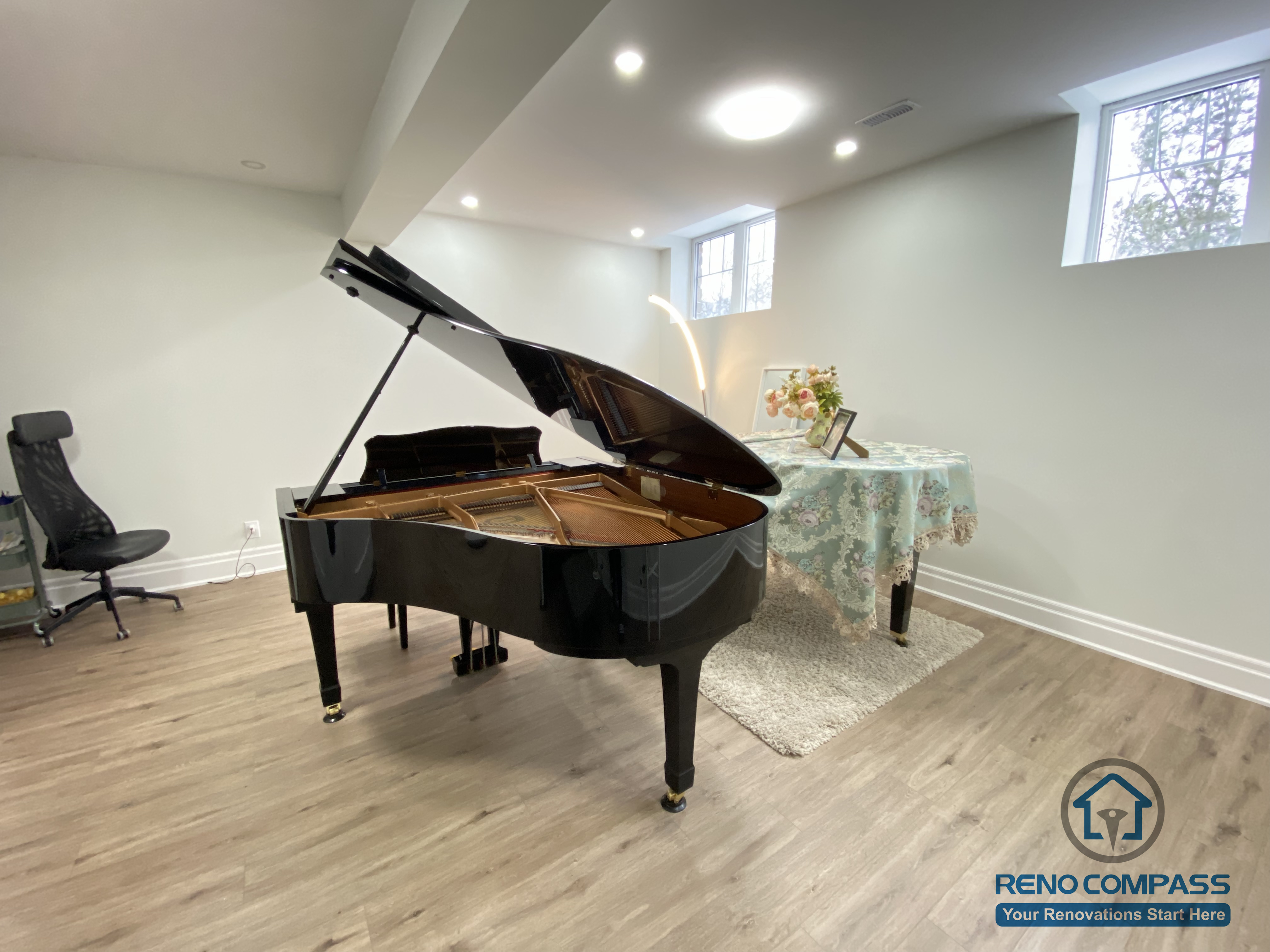 This Oakville basement renovation features a bright, open-concept music room designed for both performance and everyday enjoyment. The space includes premium wood flooring, recessed lighting, and high-set windows to enhance natural light and acoustic balance. A grand piano anchors the room, making it ideal for music practice, private lessons, or refined family entertainment. As a professional Toronto renovation company, Reno Compass focuses on layout optimization, sound-friendly materials, and long-term comfort to create functional yet elegant basement living spaces tailored to homeowners’ lifestyles.
