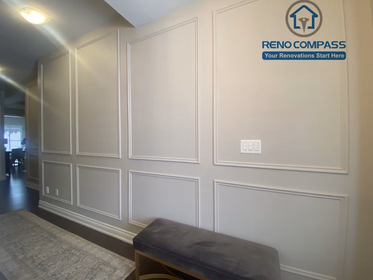 This Vaughan interior renovation features a refined hallway with custom wall paneling, clean trim details, and a long, well-proportioned layout. Subtle lighting and classic millwork enhance the sense of depth and elegance, completed by a professional Toronto renovation company.
